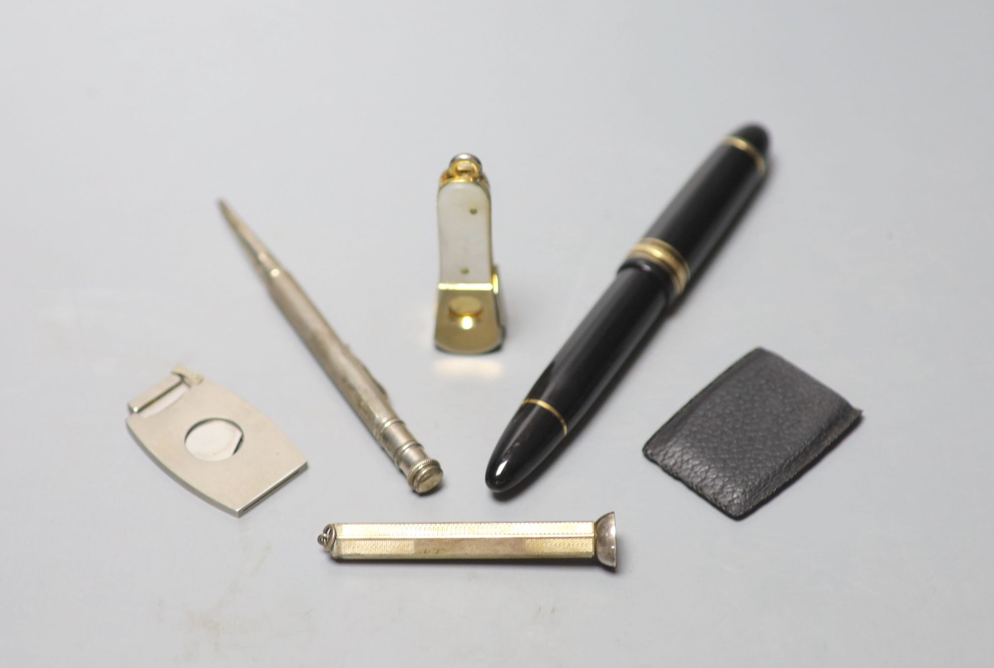 A Mont Blanc Meisterstuck No.149 pen, two silver propelling pencils, a other of pearl cigar cutter and another